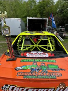 Jamie Davis Racing season opener trophy beside Green Mountain Mobile Sandblasting and Powder Coating logo
