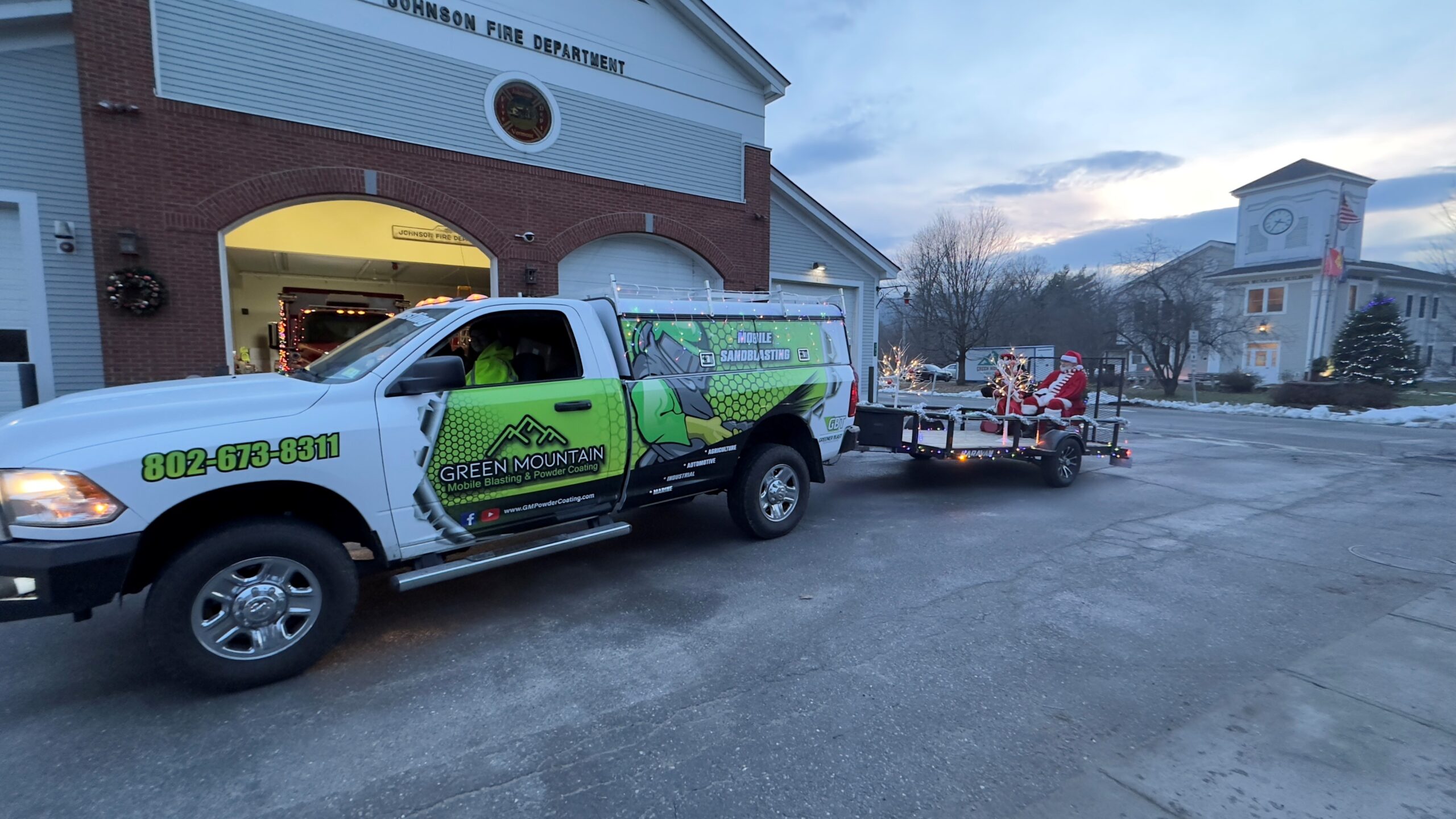 "GM Powder Coating parade truck pulling sleigh at Johnson VT Holiday Jubilee with Mrs. Claus Gigi Beach"