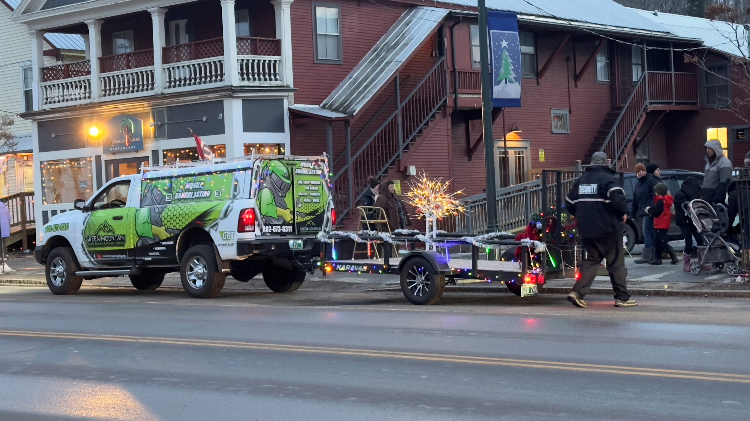 GM Powder Coating parade truck pulling sleigh at Johnson VT Holiday Jubilee with Mrs. Claus Gigi Beach