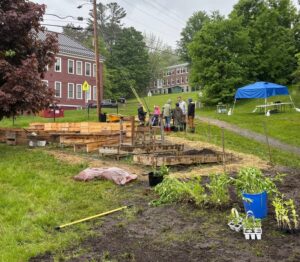 Community volunteers planting garden beds in the rain at Johnson Elementary School in Vermont
