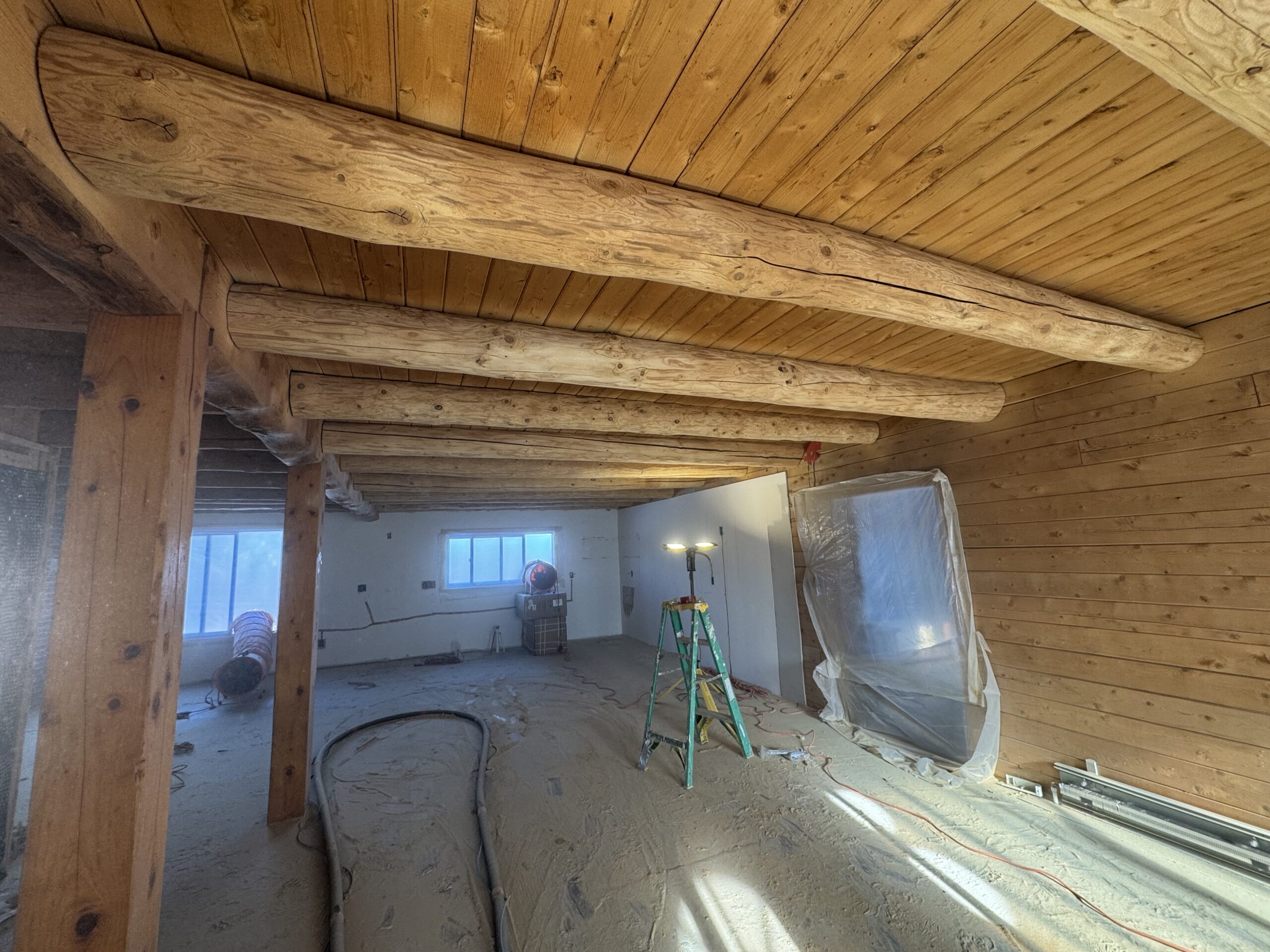 Ceiling wood beams sandblasted by Green Mountain Mobile Sandblasting and Powder Coating in Craftsbury Vermont with T&G areas left untouched