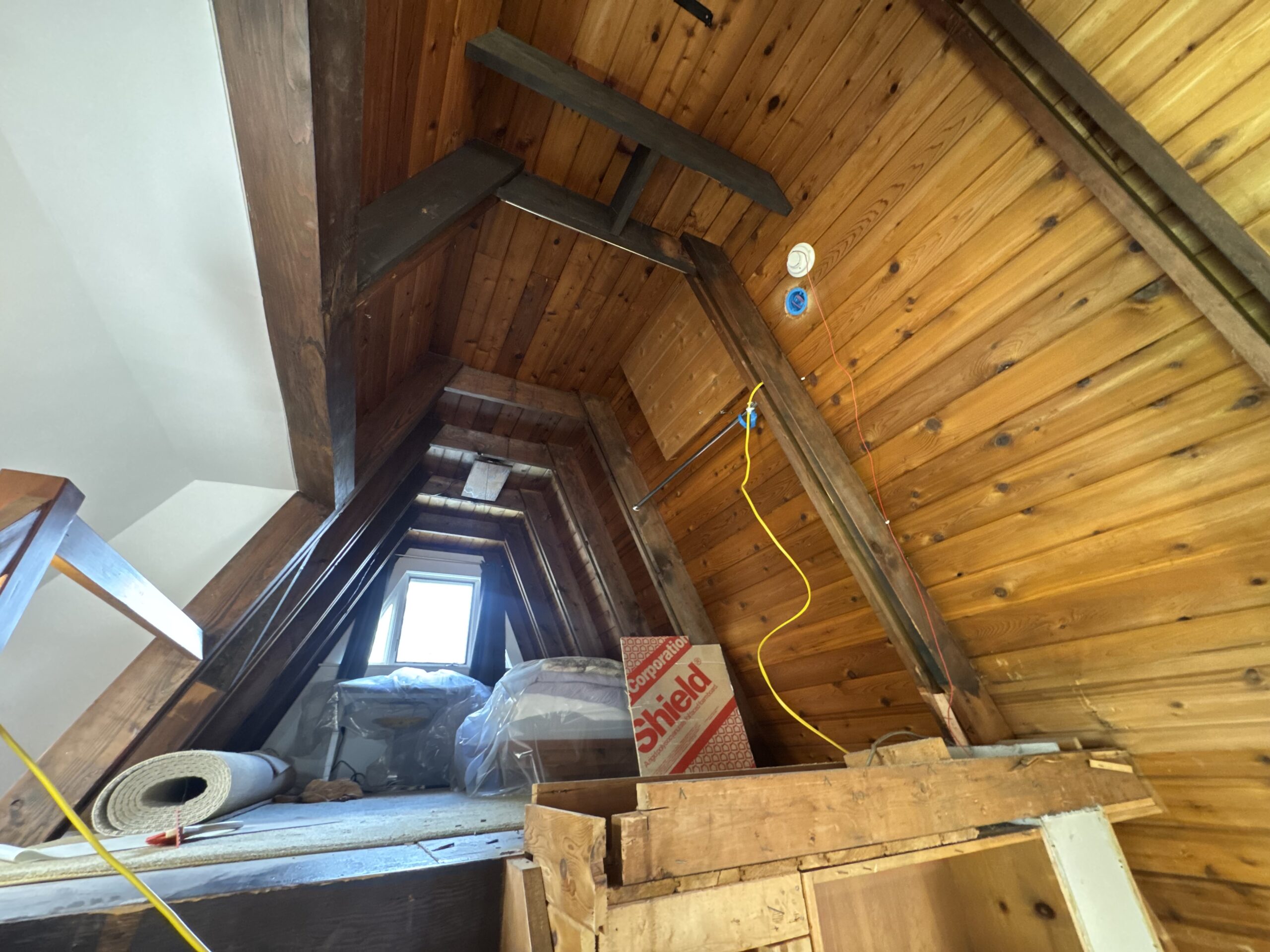 Log Cabin Interior Restoration – Before & After Sandblasting Log cabin interior sandblasting restoration showing dark brown beams and golden brown tongue and groove before and after by Green Mountain Sandblasting and Powder Coating LLC