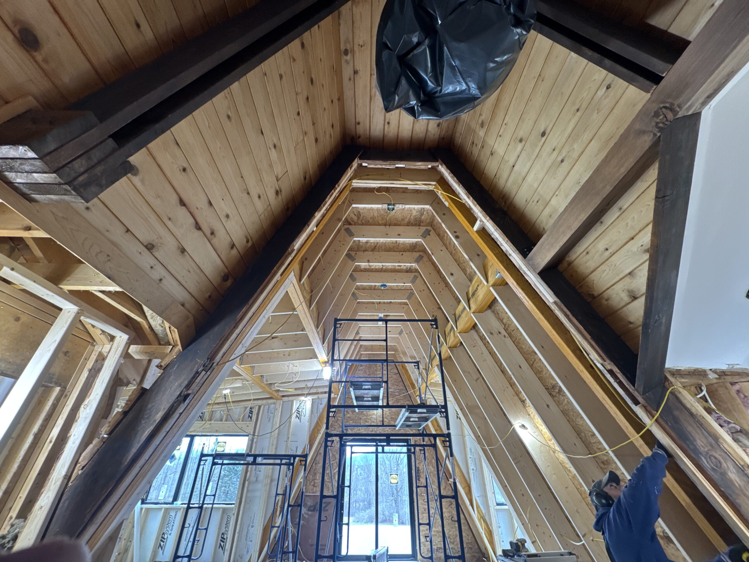 Log Cabin Interior Restoration – Before & After Sandblasting Log cabin interior sandblasting restoration showing dark brown beams and golden brown tongue and groove before and after by Green Mountain Sandblasting and Powder Coating LLC