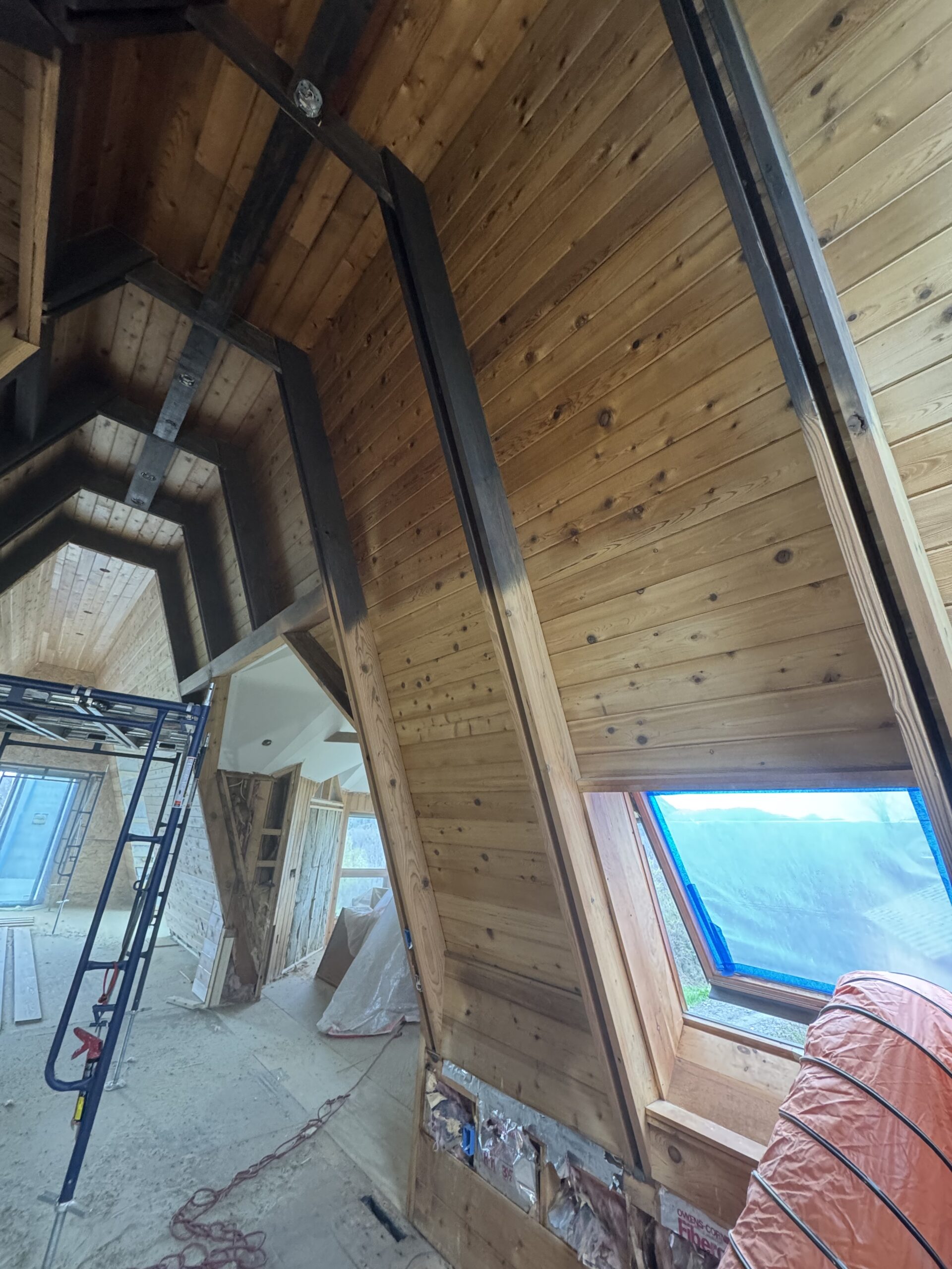 Log Cabin Interior Restoration – Before & After Sandblasting Log cabin interior sandblasting restoration showing dark brown beams and golden brown tongue and groove before and after by Green Mountain Sandblasting and Powder Coating LLC