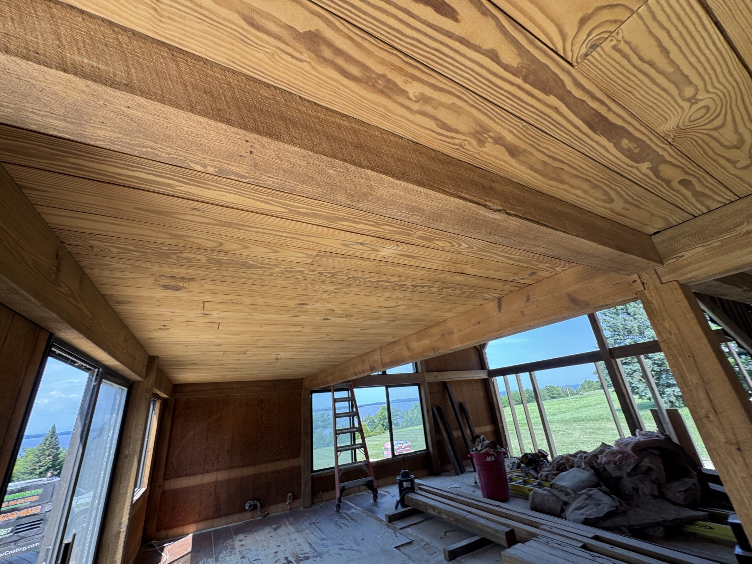Lake Champlain Cabin – Interior Wood Sandblasting Restoration Cabin interior ceilings and wood beams sandblasted on Lake Champlain by Green Mountain Sandblasting and Powder Coating LLC showing before during and after restoration