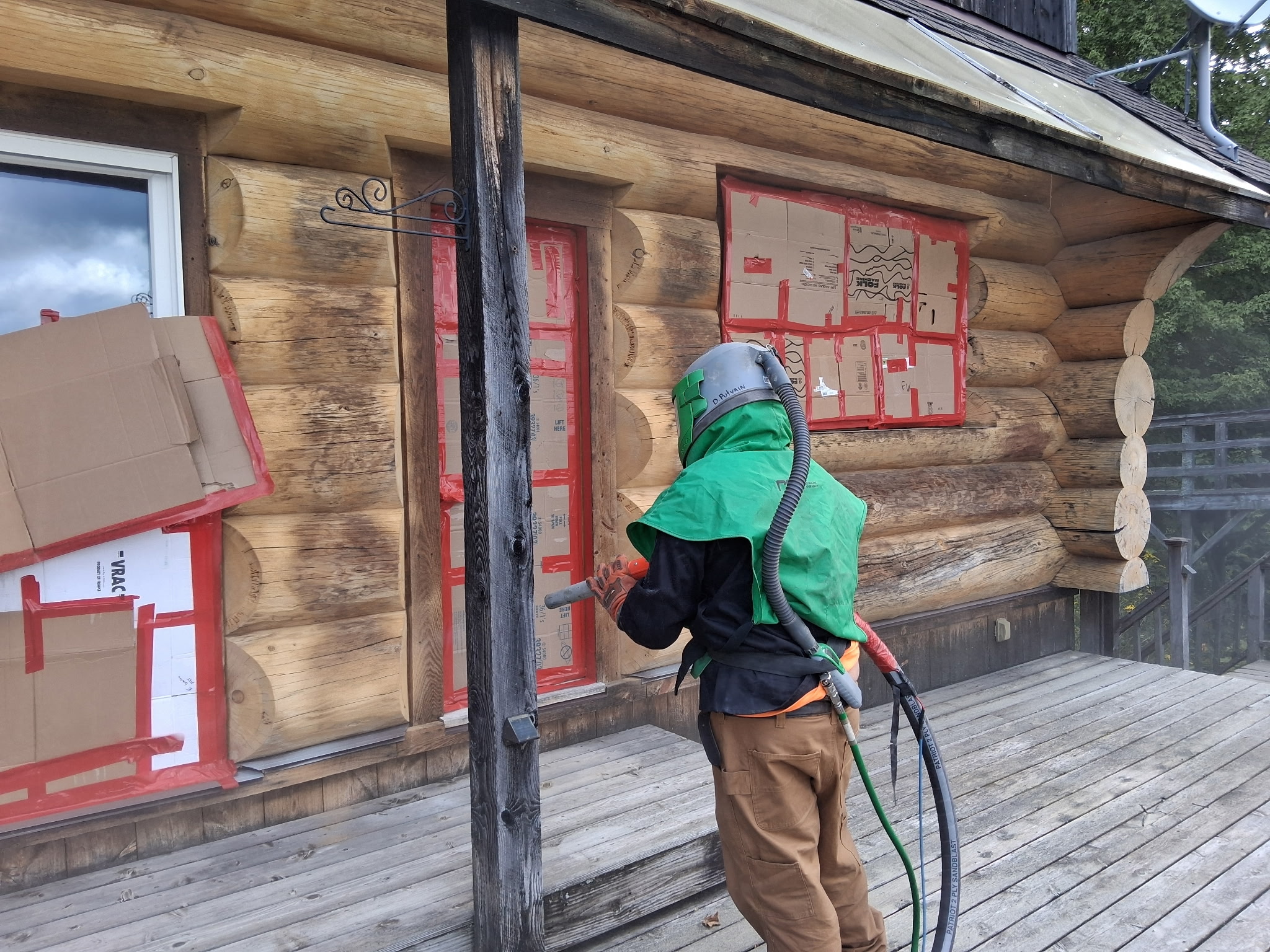 Log Cabin Sandblasting & Weathering Removal – Roxbury, Vermont Before and after log cabin restoration in Roxbury Vermont showing gray weathered logs sandblasted back to clean natural wood