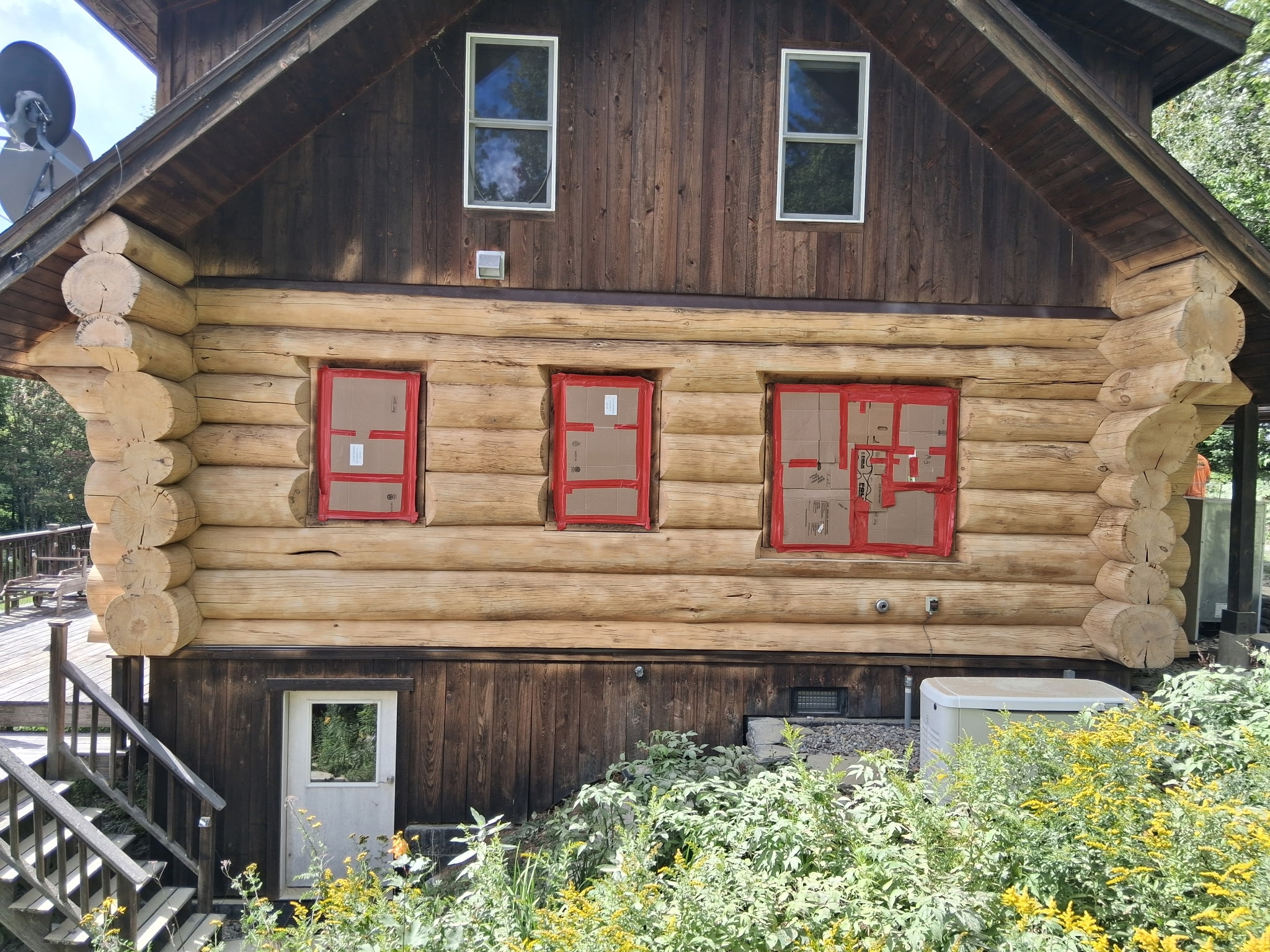 Log Cabin Sandblasting & Weathering Removal – Roxbury, Vermont Before and after log cabin restoration in Roxbury Vermont showing gray weathered logs sandblasted back to clean natural wood