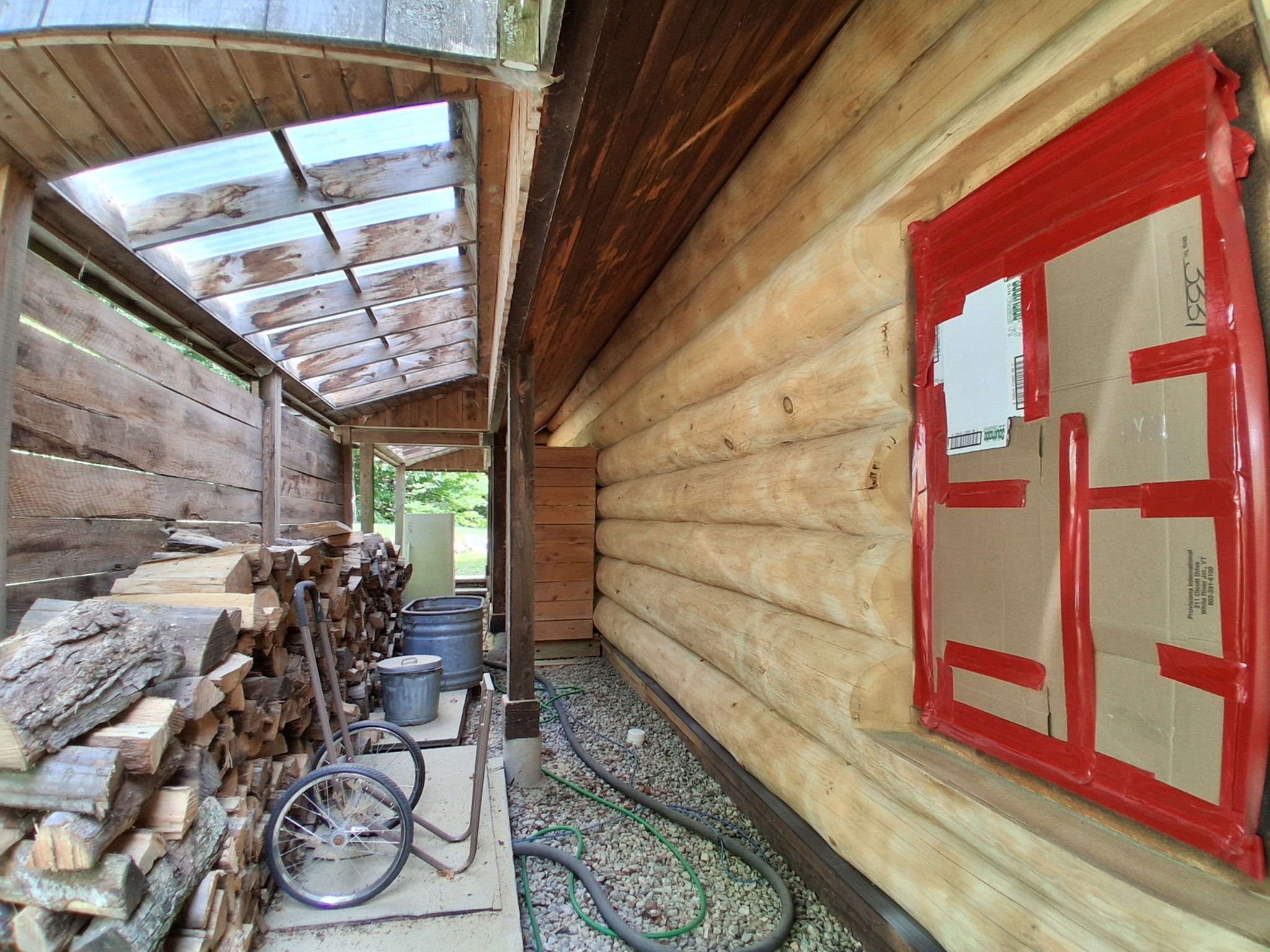 Log Cabin Sandblasting & Weathering Removal – Roxbury, Vermont Before and after log cabin restoration in Roxbury Vermont showing gray weathered logs sandblasted back to clean natural wood