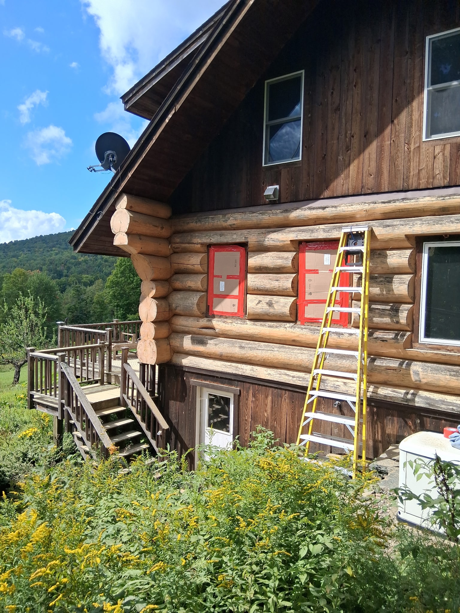 Log Cabin Sandblasting & Weathering Removal – Roxbury, Vermont Before and after log cabin restoration in Roxbury Vermont showing gray weathered logs sandblasted back to clean natural wood