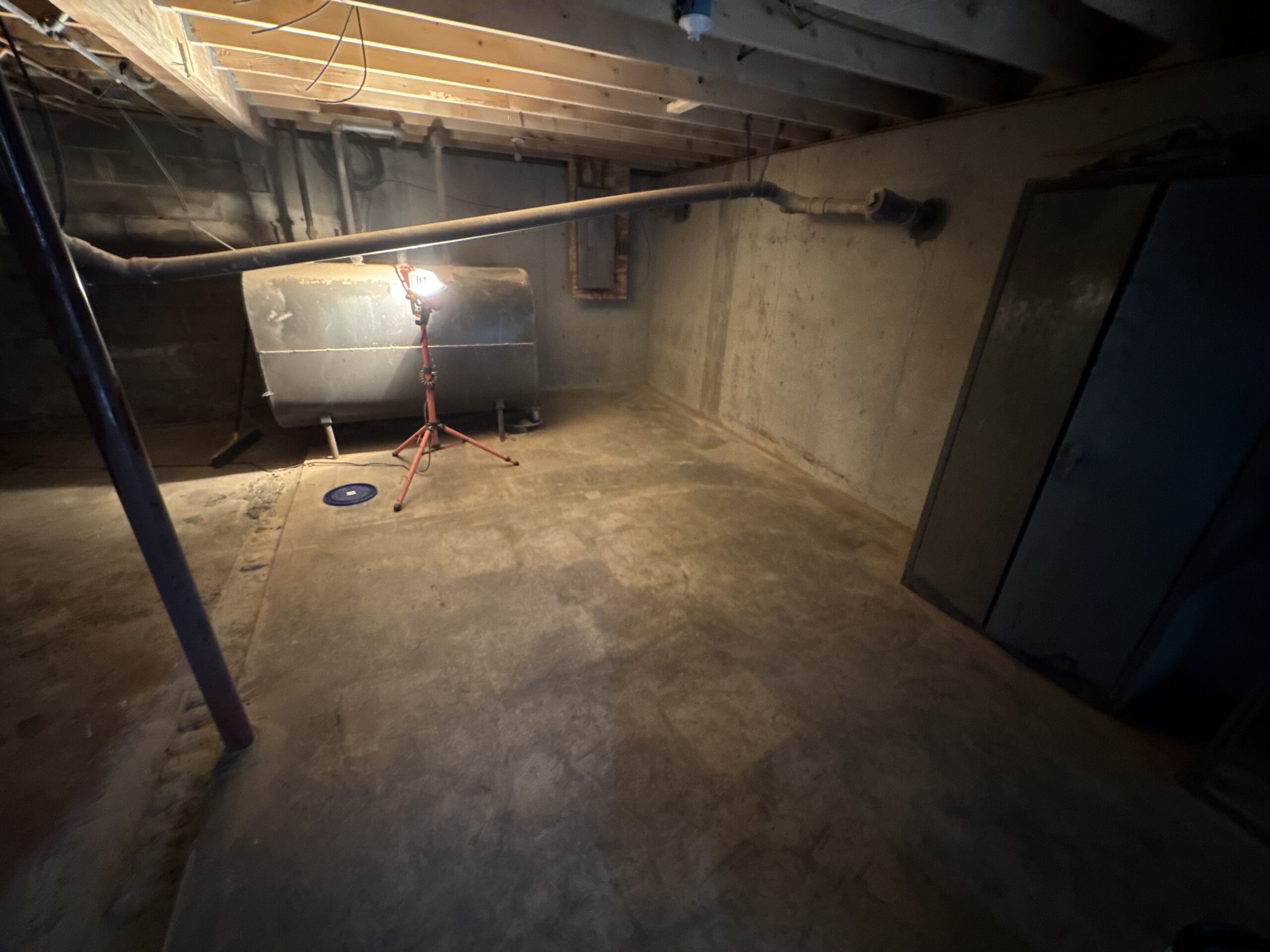 Fire Damage Sandblasting – Bristol, Vermont Before and after fire damage restoration in Bristol Vermont showing sandblasted wood floor joists and concrete basement walls