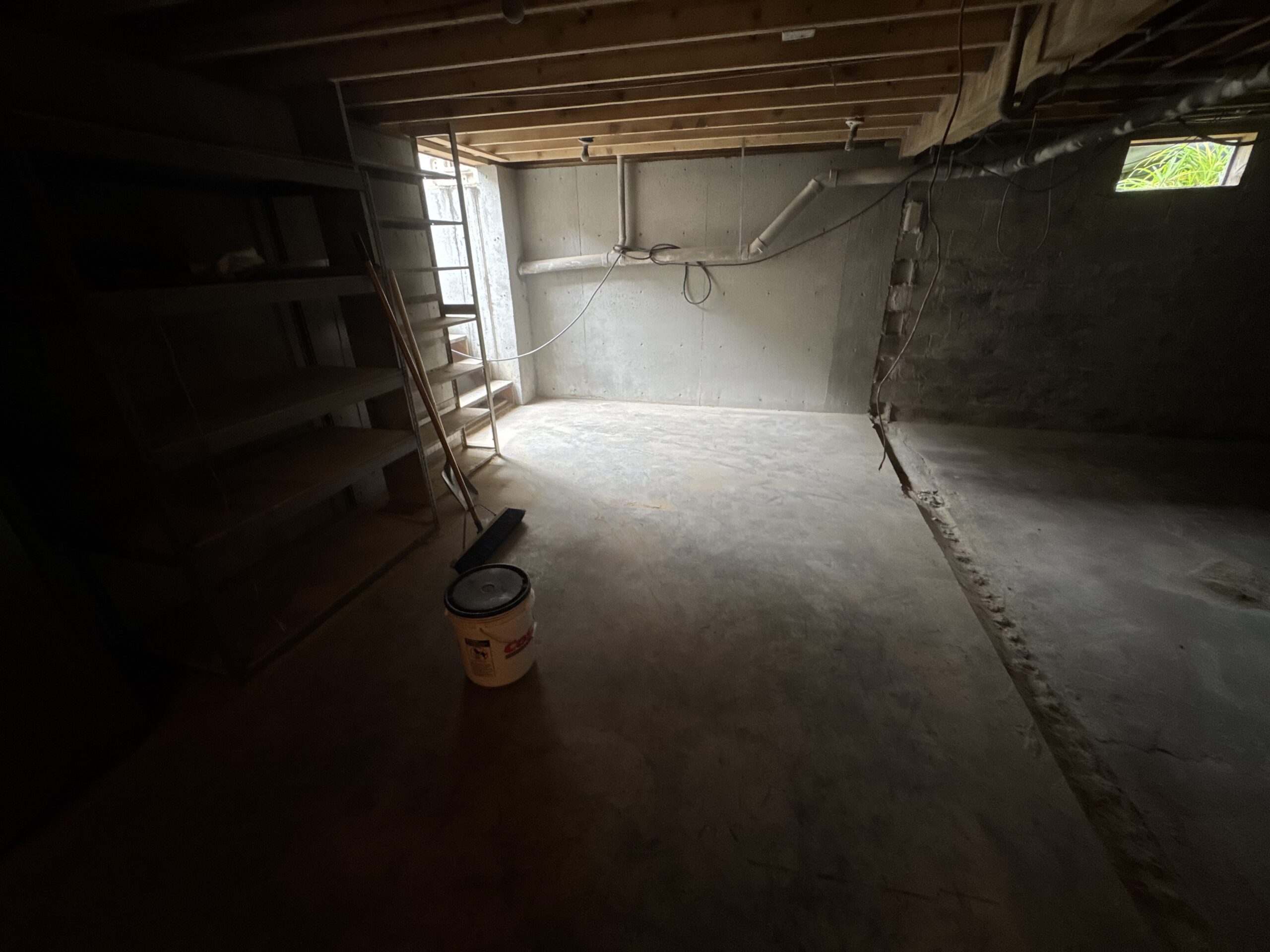 Fire Damage Sandblasting – Bristol, Vermont Before and after fire damage restoration in Bristol Vermont showing sandblasted wood floor joists and concrete basement walls