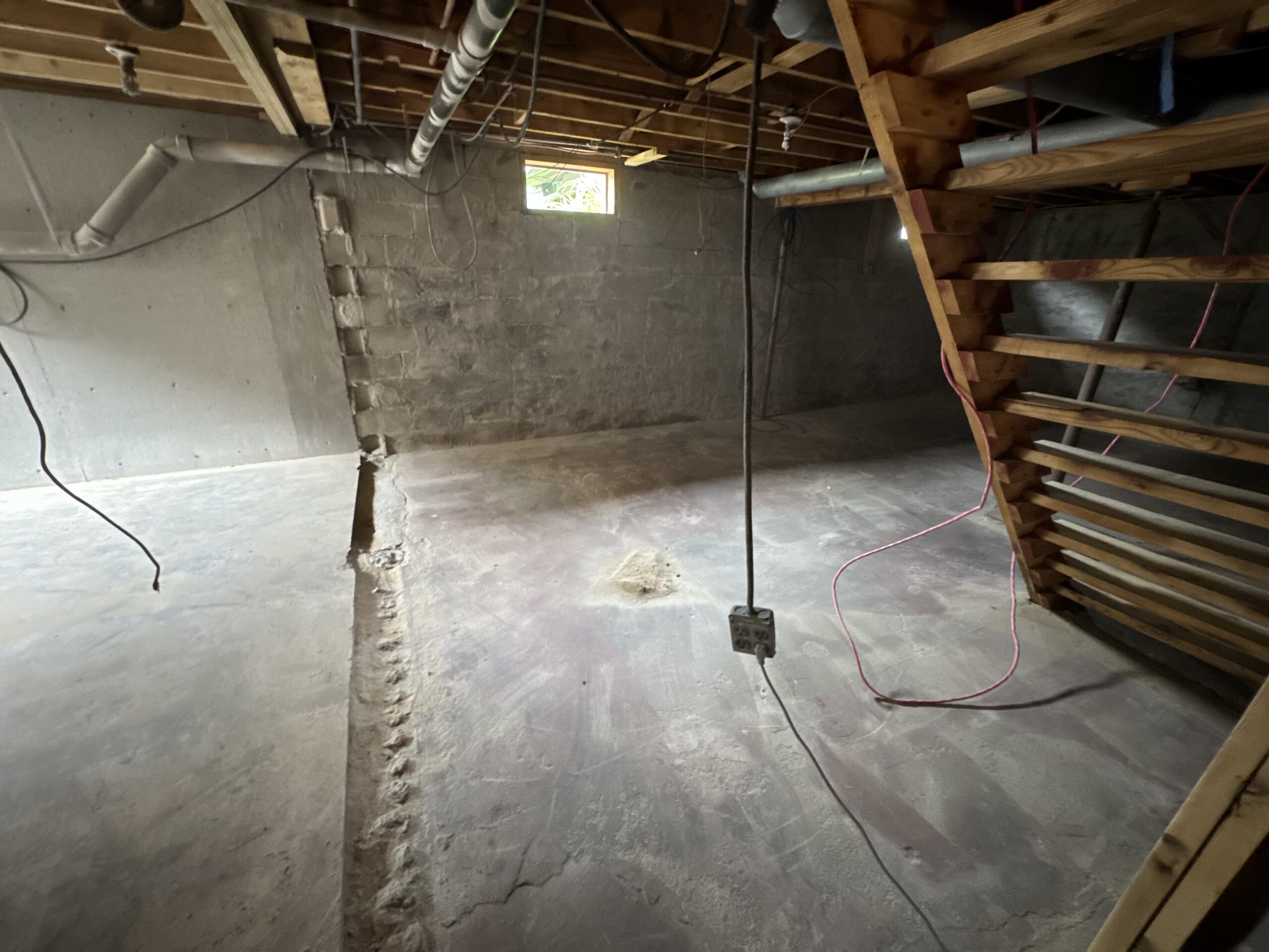 Fire Damage Sandblasting – Bristol, Vermont Before and after fire damage restoration in Bristol Vermont showing sandblasted wood floor joists and concrete basement walls