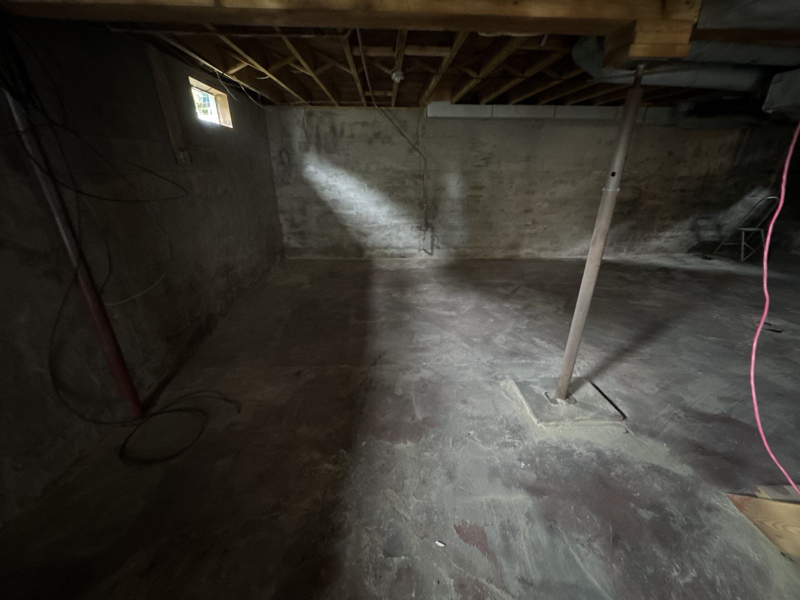Fire Damage Sandblasting – Bristol, Vermont Before and after fire damage restoration in Bristol Vermont showing sandblasted wood floor joists and concrete basement walls