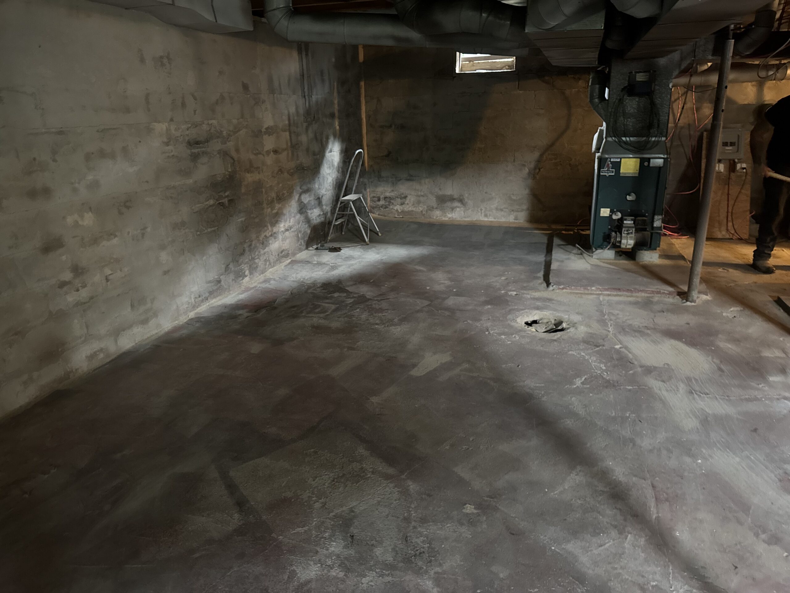 Fire Damage Sandblasting – Bristol, Vermont Before and after fire damage restoration in Bristol Vermont showing sandblasted wood floor joists and concrete basement walls