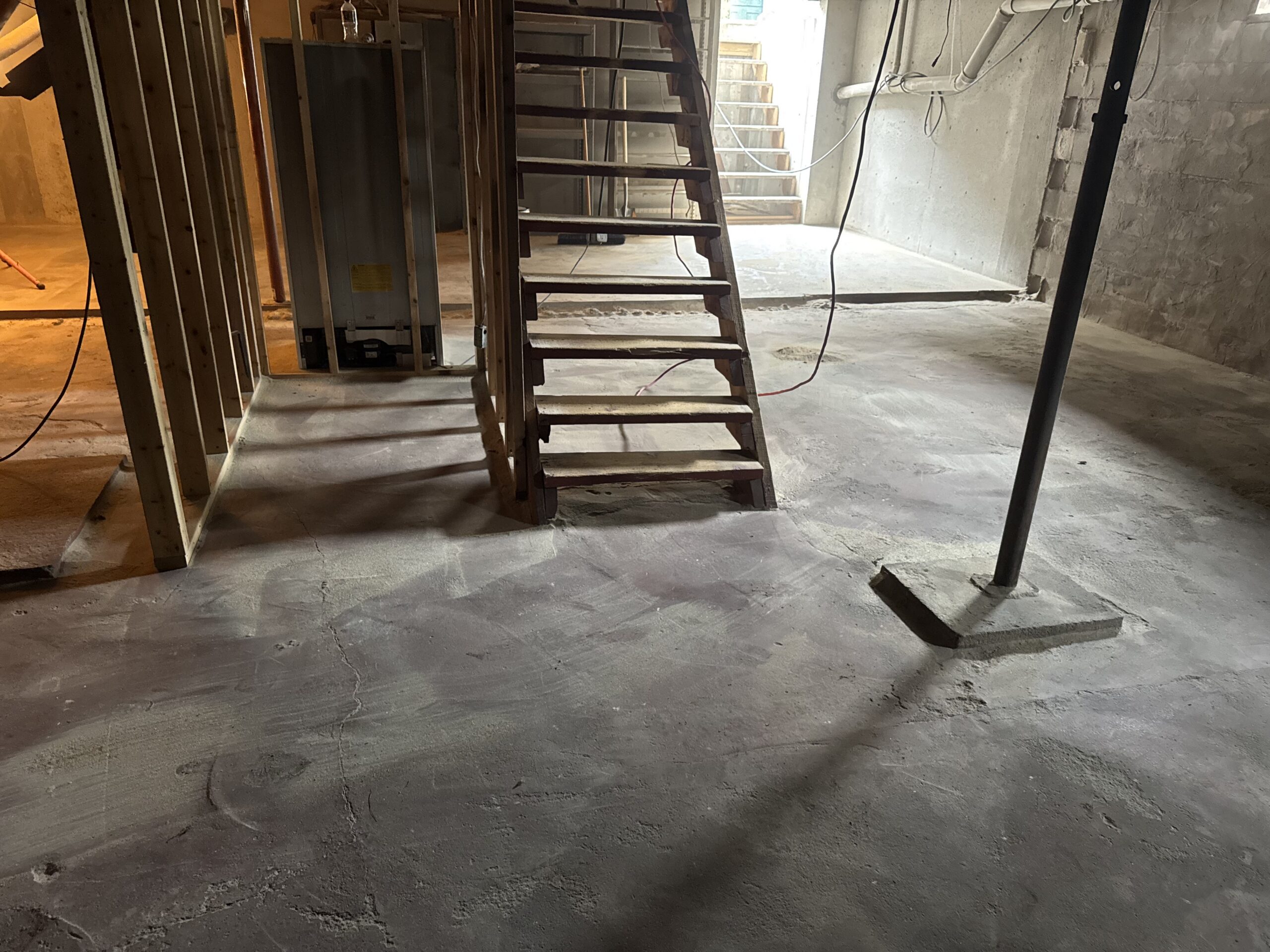 Fire Damage Sandblasting – Bristol, Vermont Before and after fire damage restoration in Bristol Vermont showing sandblasted wood floor joists and concrete basement walls