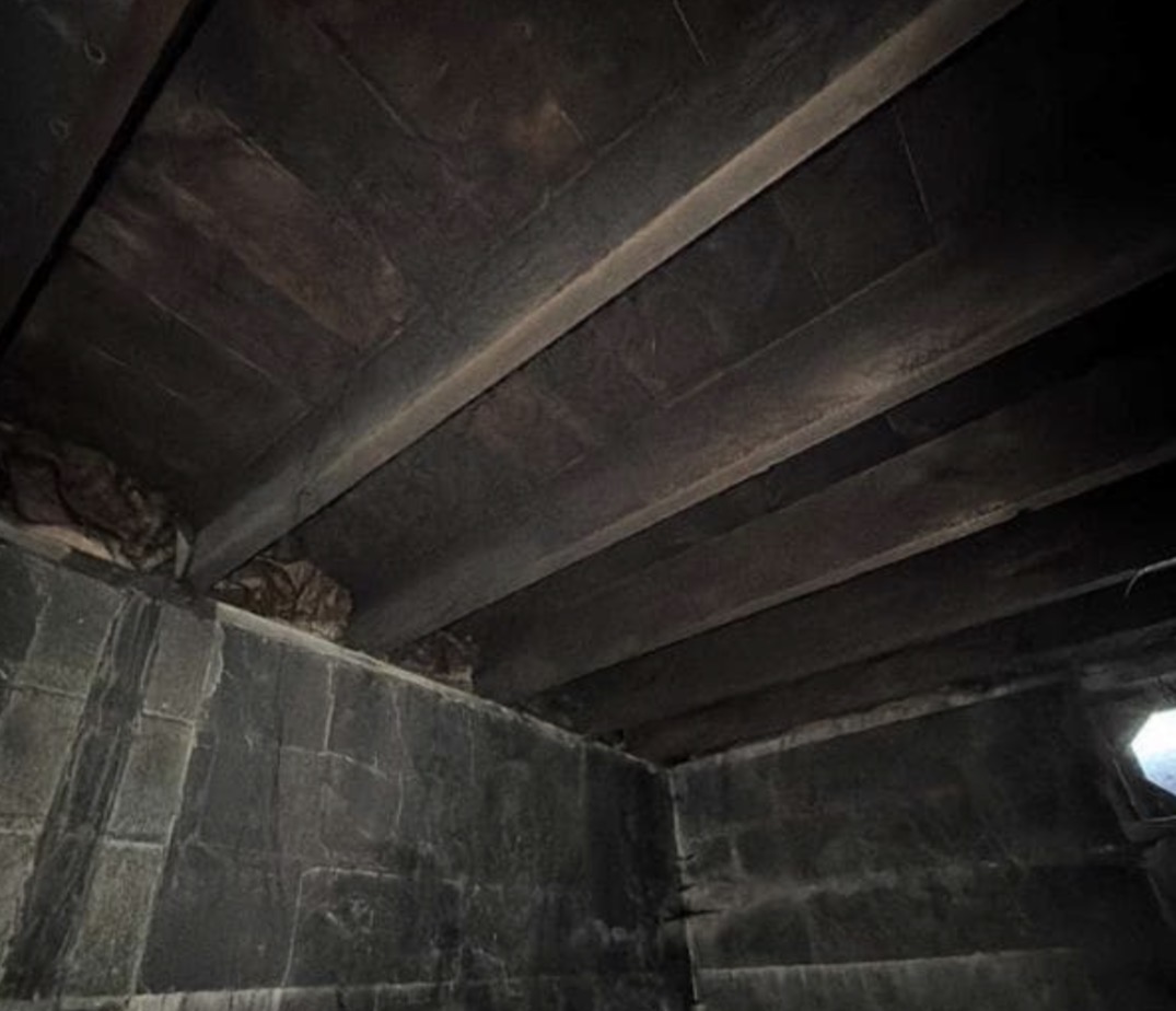 Fire Damage Sandblasting – Bristol, Vermont Before and after fire damage restoration in Bristol Vermont showing sandblasted wood floor joists and concrete basement walls