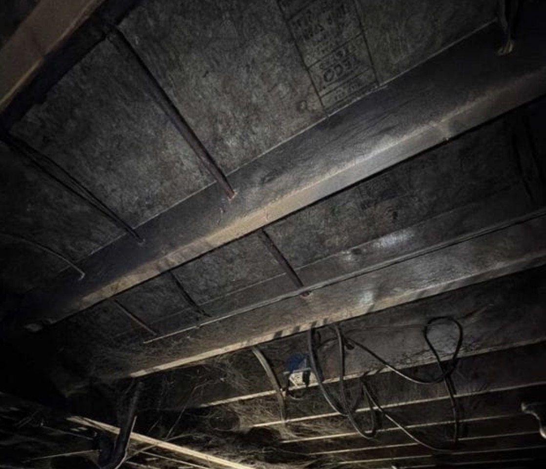 Fire Damage Sandblasting – Bristol, Vermont Before and after fire damage restoration in Bristol Vermont showing sandblasted wood floor joists and concrete basement walls