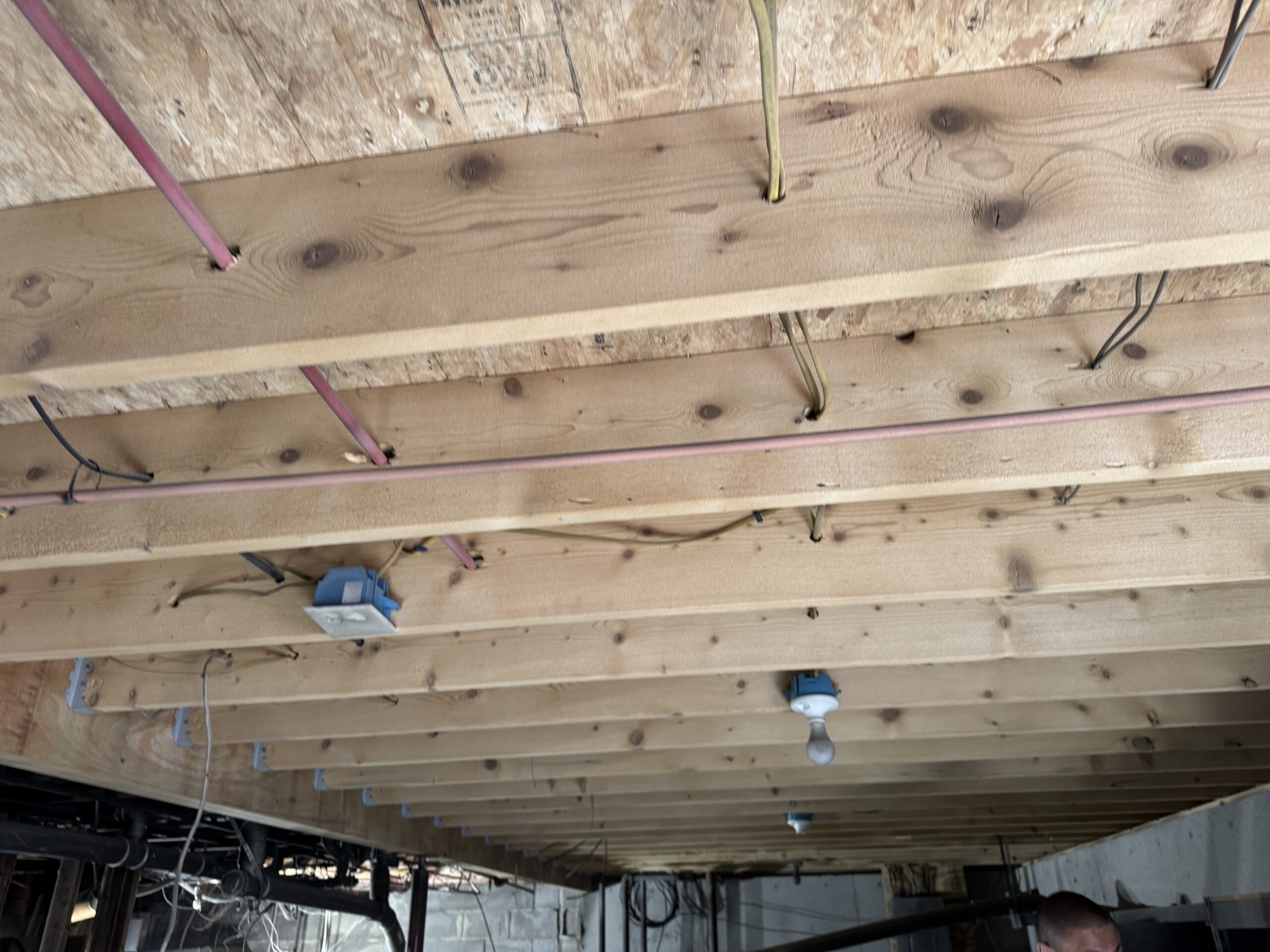 Fire Damage Sandblasting – Bristol, Vermont Before and after fire damage restoration in Bristol Vermont showing sandblasted wood floor joists and concrete basement walls