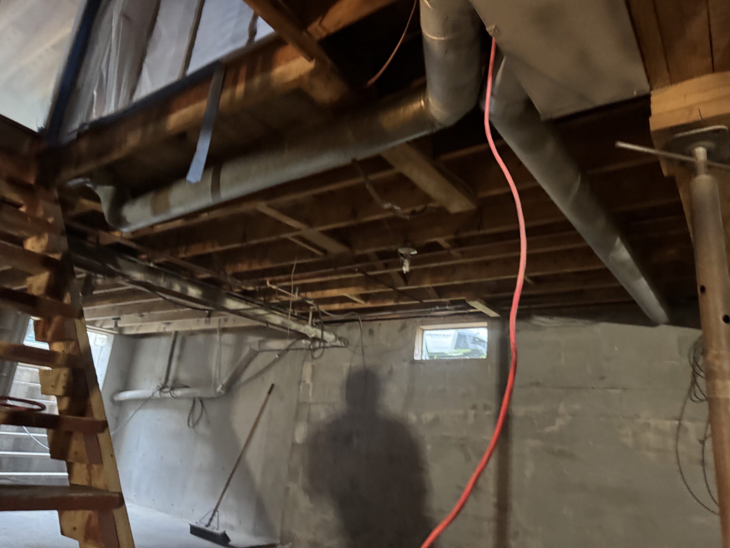Fire Damage Sandblasting – Bristol, Vermont Before and after fire damage restoration in Bristol Vermont showing sandblasted wood floor joists and concrete basement walls