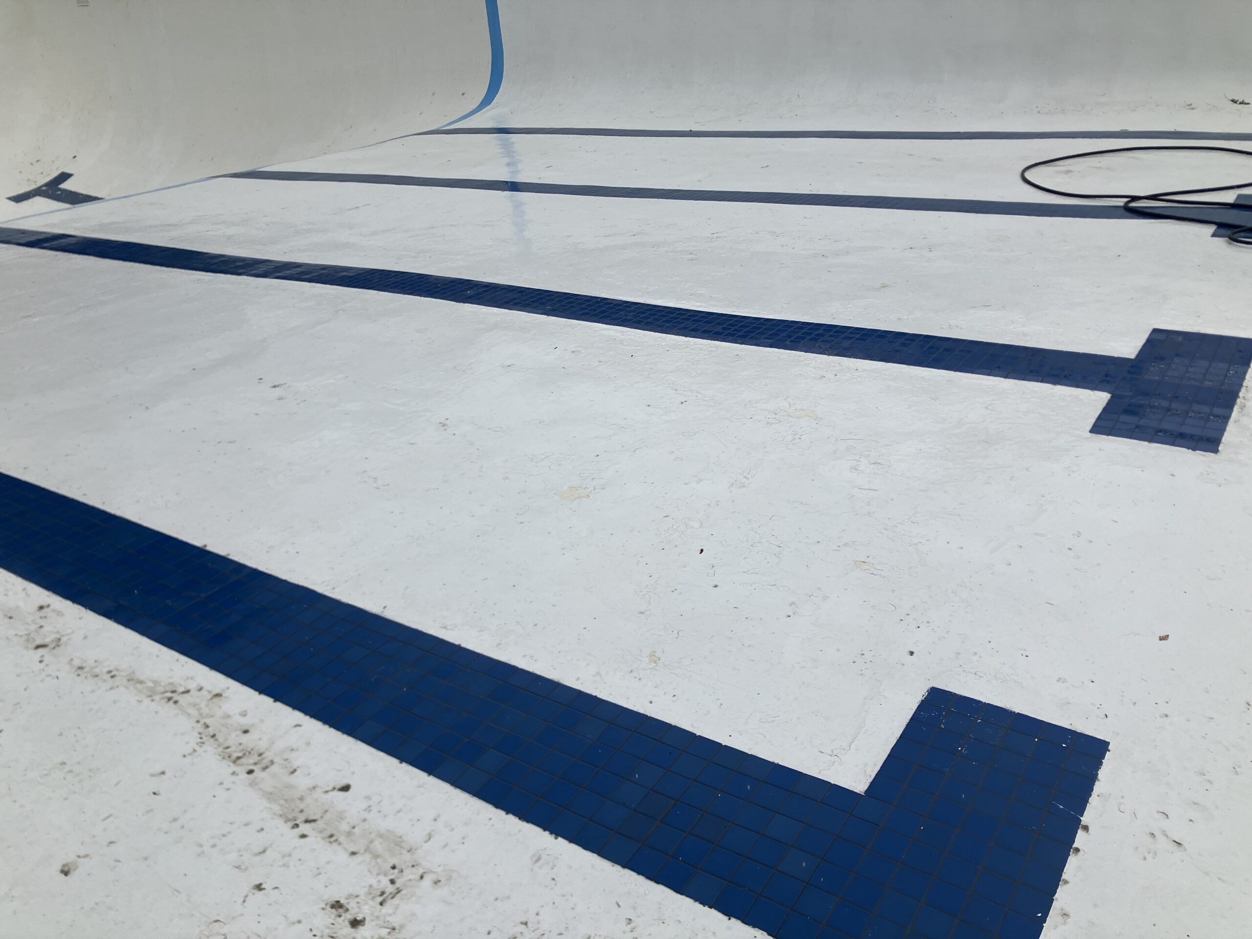 Swimming Pool Paint Etching – Smugglers’ Notch Resort, Jeffersonville, Vermont Swimming pool at Smugglers’ Notch Resort in Jeffersonville Vermont professionally sandblasted to etch the existing painted surface for a new coating