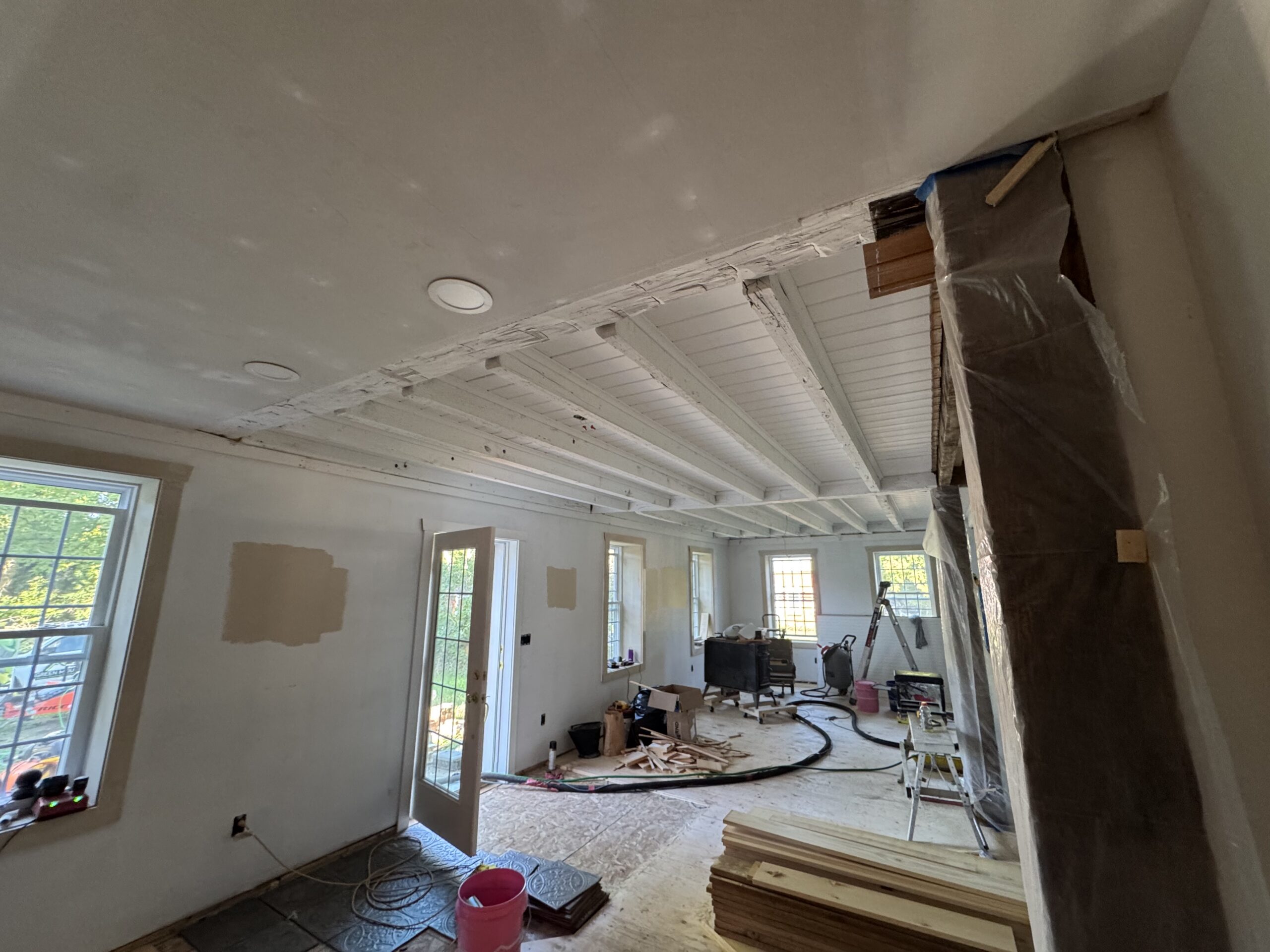 Interior Wood Beam Sandblasting – Isle La Motte, Vermont Interior ceiling beams in an Isle La Motte Vermont home selectively sandblasted to remove paint while leaving the surrounding wood untouched