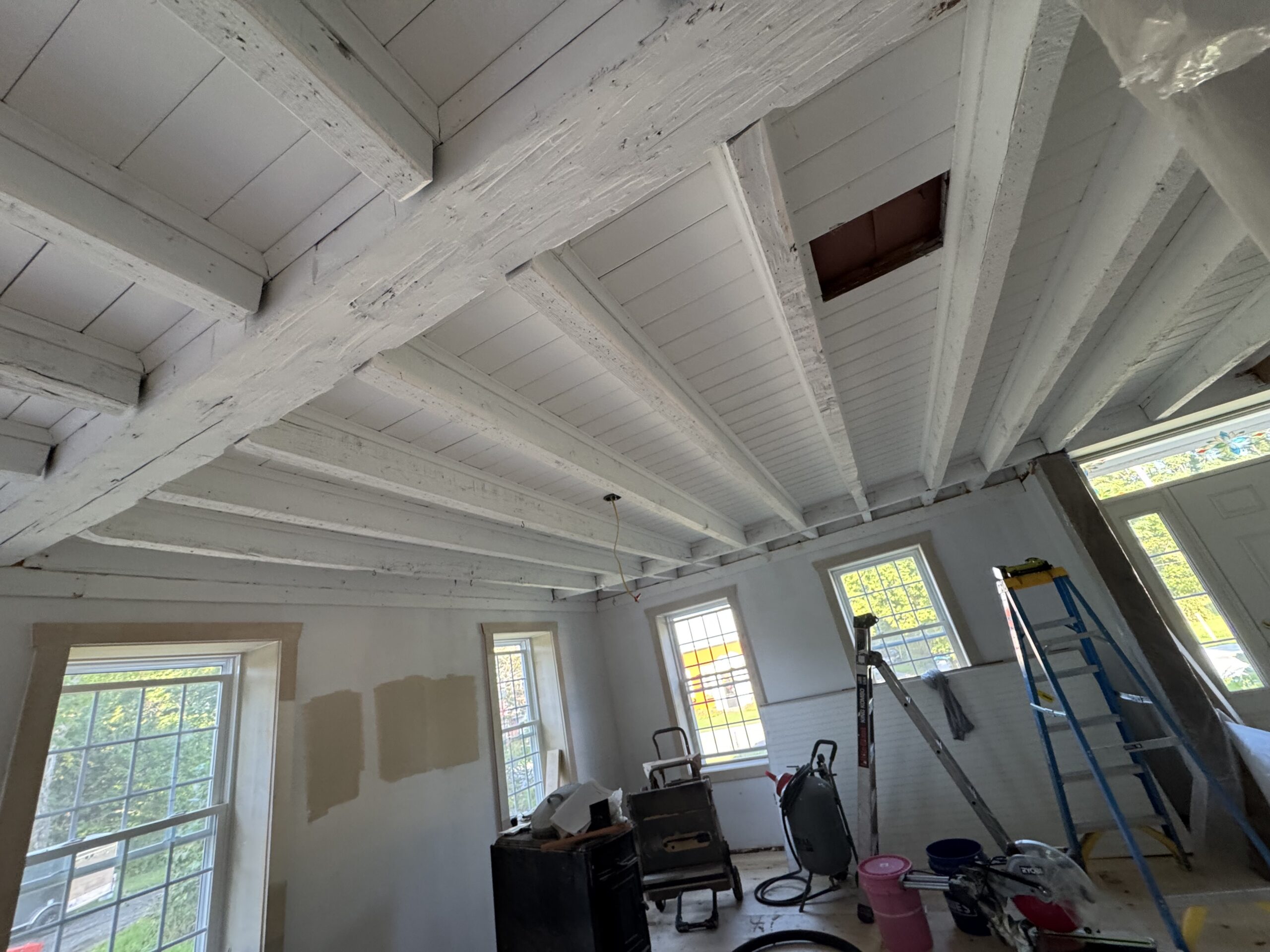 Interior Wood Beam Sandblasting – Isle La Motte, Vermont Interior ceiling beams in an Isle La Motte Vermont home selectively sandblasted to remove paint while leaving the surrounding wood untouched