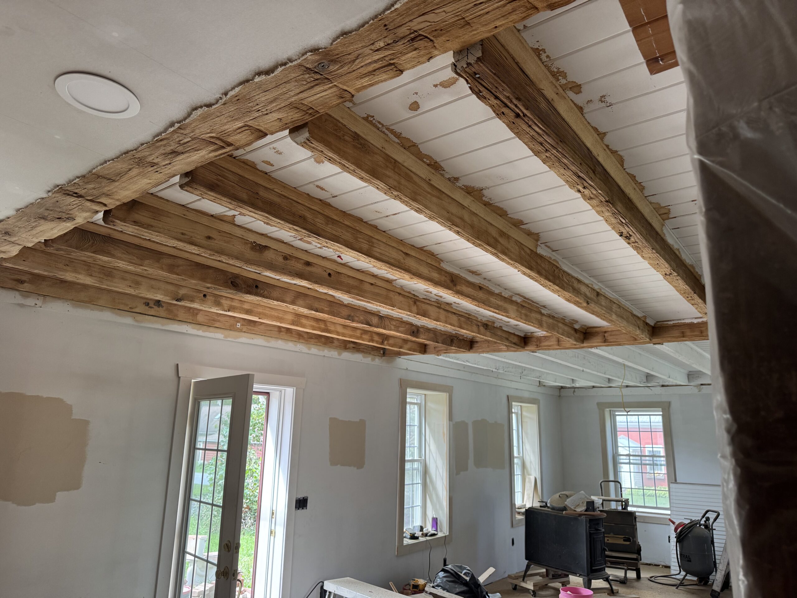 Interior Wood Beam Sandblasting – Isle La Motte, Vermont Interior ceiling beams in an Isle La Motte Vermont home selectively sandblasted to remove paint while leaving the surrounding wood untouched