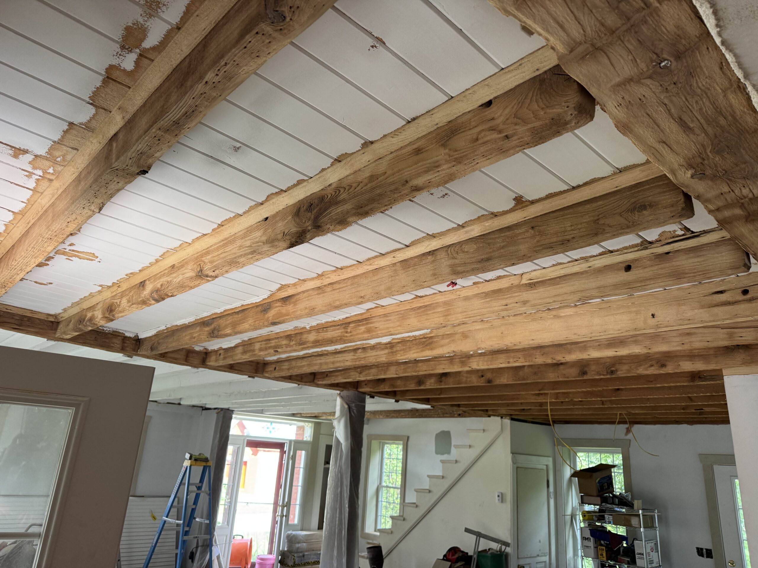 Interior Wood Beam Sandblasting – Isle La Motte, Vermont Interior ceiling beams in an Isle La Motte Vermont home selectively sandblasted to remove paint while leaving the surrounding wood untouched