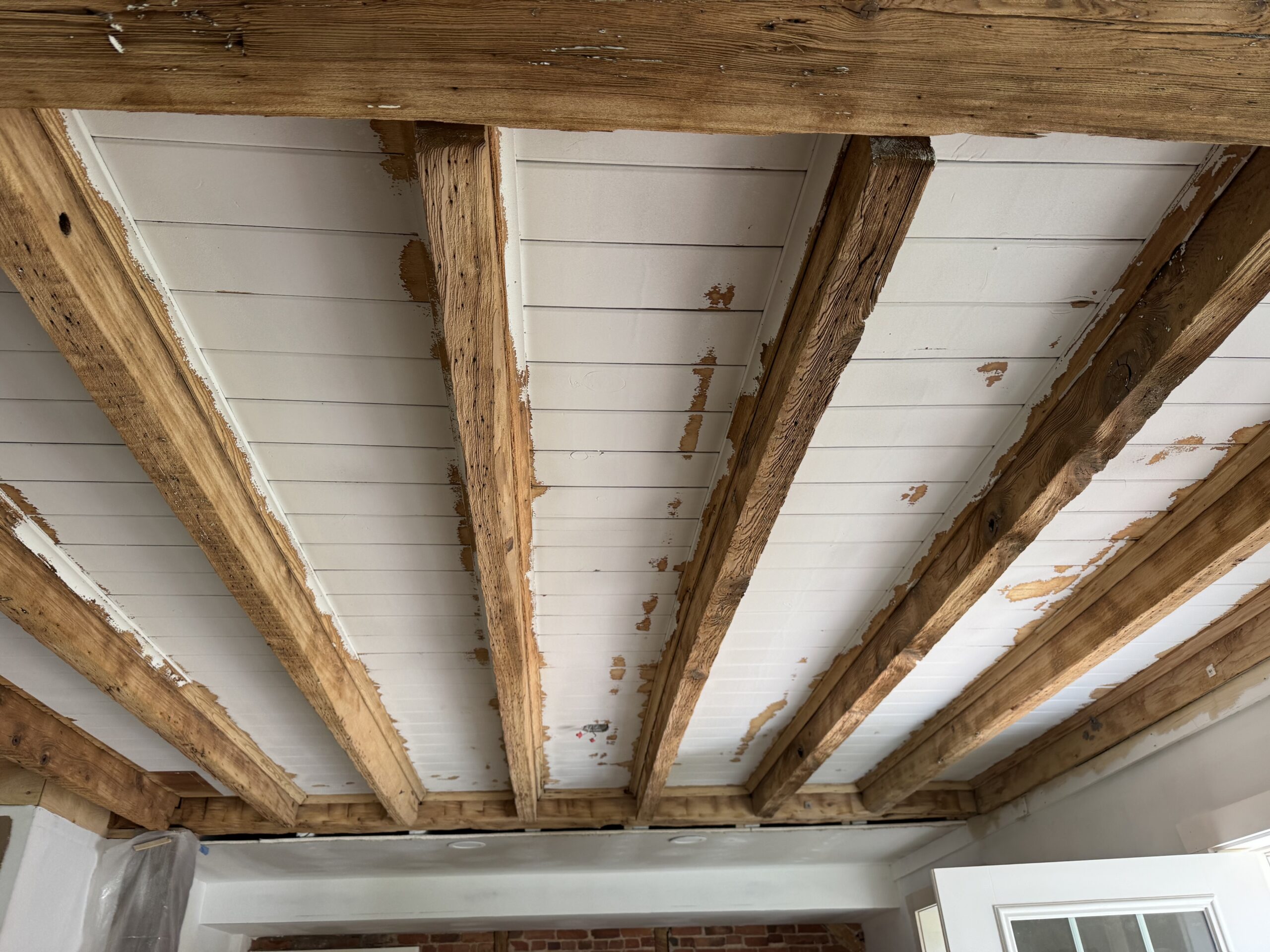 Interior Wood Beam Sandblasting – Isle La Motte, Vermont Interior ceiling beams in an Isle La Motte Vermont home selectively sandblasted to remove paint while leaving the surrounding wood untouched