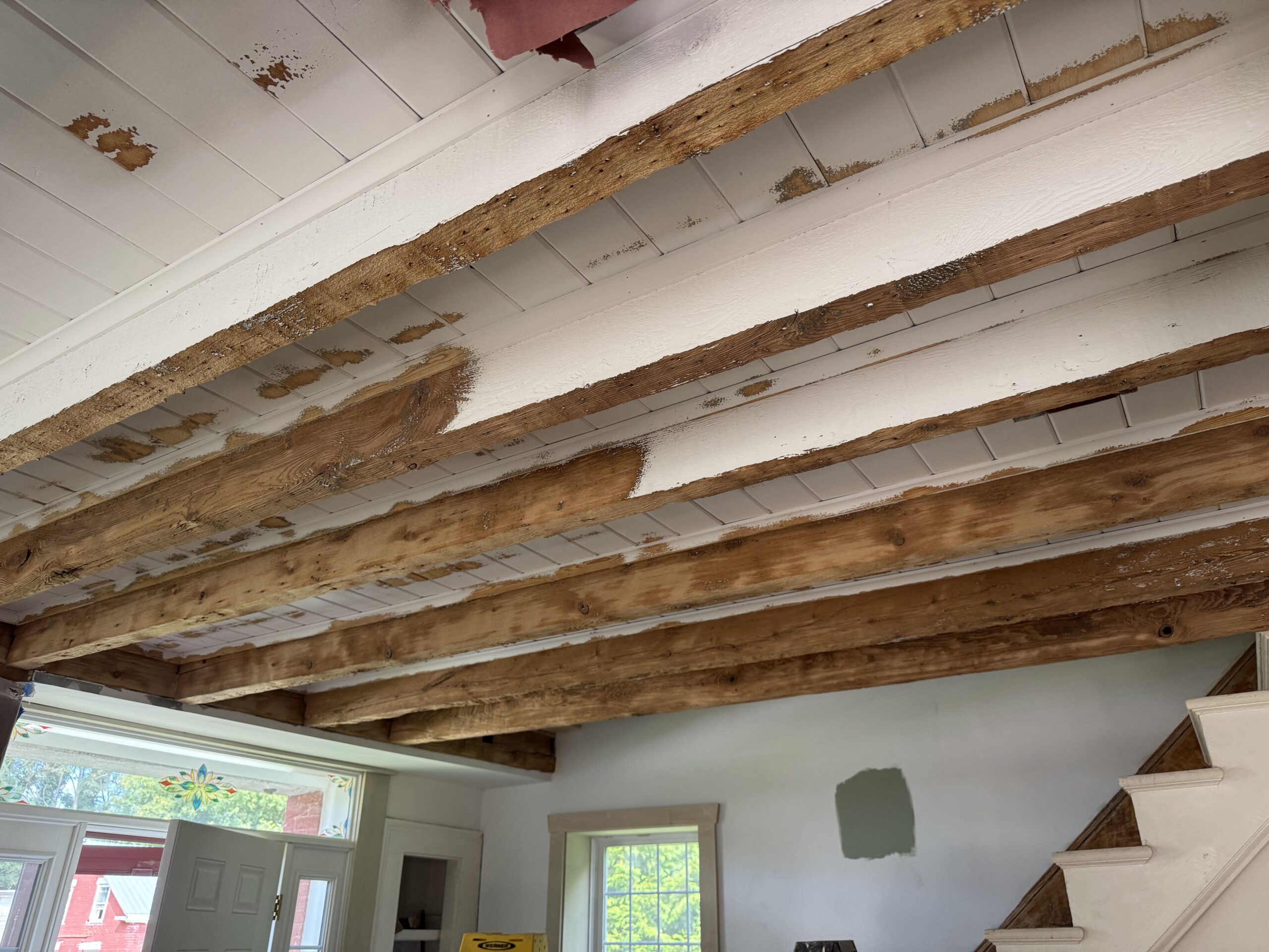 Interior Wood Beam Sandblasting – Isle La Motte, Vermont Interior ceiling beams in an Isle La Motte Vermont home selectively sandblasted to remove paint while leaving the surrounding wood untouched