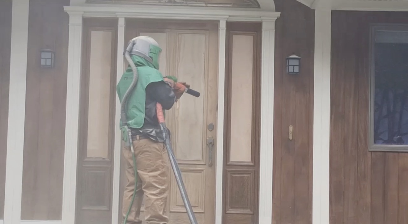 Front Door & Entryway Wood Restoration – Rutland, Vermont Before and after restoration of a weathered wood front door entryway in Rutland Vermont, sandblasted back to fresh wood and finished with a light golden sealer